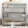 A triple bunk bed with bedding and pillows, a teddy bear sits on the bottom bunk. Anteprima dell’immagine prodotto
