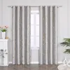 A pair of gray curtains with a gold marble-like pattern hanging in front of a window. Produktbild-Vorschau
