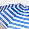 A close-up view of a striped beach umbrella. Produktbild-Vorschau