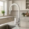 A modern kitchen sink area with a white faucet. Produktbild-Vorschau