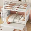 A white bunk bed with a pull-out trundle bed, dressed in bedding and pillows, in a child's bedroom. Produktbild-Vorschau