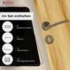 A close-up of a door handle set and its included components, displayed against a wooden door. Produktbild-Vorschau