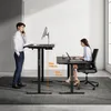 Two people are using standing desks in a modern office setting. Anteprima dell’immagine prodotto