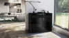 A modern living room with a black sideboard, sofa, and large window. Produktbild-Vorschau