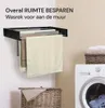 A wall-mounted drying rack with towels hanging on it, next to a washing machine and a laundry basket. Náhľad obrázku produktu