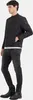 A man wearing a black jacket and jeans, posing against a white background. Produktbild-Vorschau