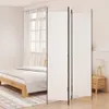 A bedroom scene with a bed, a room divider, and a nightstand with a lamp. Voir les images du produit