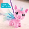 A pink plush unicorn toy with blue wings is shown on a textured surface, with a purple leash attached. Náhled obrázku produktu