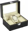 An open black watch organizer box with a clear lid, displaying one silver and gold watch on a cream-colored cushion. Náhled obrázku produktu