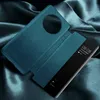 A teal flip case for a Huawei Mate 50 Pro phone is displayed on a dark, silky fabric background. Produktbild-Vorschau