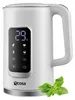 A white electric kettle with a digital display and a sprig of mint in the foreground. Náhled obrázku produktu