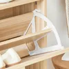 Close-up of a shoe rack with a white plastic shoe holder mechanism. Náhľad obrázku produktu