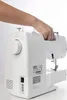 A hand is holding the handle of a white Brother sewing machine against a white background. Produktbild-Vorschau