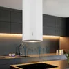 A modern kitchen with a white island range hood installed above a countertop with a sink and stovetop. The background features dark cabinetry and warm accent lighting. Náhľad obrázku produktu