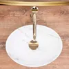 A top-down view of a marble sink with a gold faucet. Náhled obrázku produktu