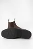 A pair of brown leather Chelsea boots shown from a low angle, with one boot placed on top of the other, displaying the sole of the bottom boot. Produktbild-Vorschau