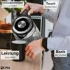 A person is pouring water from a glass electric kettle into a mug on a kitchen counter. Produktbild-Vorschau