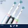 Three Oral-B iO 3 electric toothbrushes in different colors (blue, black, pink) are displayed diagonally against a light gray background. The bottom of the image features a dark blue bar with icons and text indicating '3 Modes'. Voir les images du produit