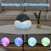 An air purifier with LED lighting on a coffee table in a living room setting. Produktbild-Vorschau
