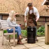 A couple is enjoying a barbecue in their backyard. Produktbild-Vorschau