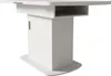 A modern white dining table with a gold accent, presented against a white background. Voir les images du produit
