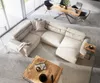 A modern living room with a large sectional sofa, coffee table, and dining area. Produktbild-Vorschau