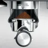 Close-up of the portafilter and grounds of an espresso machine. Produktbild-Vorschau