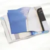 A folded blanket with a printed image of a blue sky and a white structure. Anteprima dell’immagine prodotto