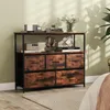 A dresser with fabric drawers and shelves in a bedroom setting. Anteprima dell’immagine prodotto
