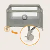 A close-up view of a baby travel cot's wheel mechanism, with an arrow indicating movement. Produktbild-Vorschau