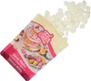 A bag of white candy melts is shown spilling out onto a white background, with a colorful illustration of decorated cakes and popsicles on the bag. Náhled obrázku produktu