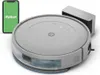 A robot vacuum cleaner, its charging dock, and a smartphone displaying a green screen with the word 'Robot' on it. Voir les images du produit
