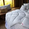 A cozy bedroom scene with a white duvet on a bed, near a window with natural light. Produktbild-Vorschau