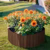 A wooden planter filled with orange flowers in a garden setting. Voir les images du produit
