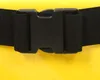 A close-up of a black buckle and strap on a yellow background. Podgląd zdjęcia produktu