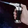 A hand holds a silver and black torch lighter with a blue flame. Náhľad obrázku produktu