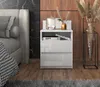 A modern bedroom scene featuring a nightstand next to a bed, with decorative items on top of the nightstand. Podgląd zdjęcia produktu