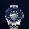 A close-up studio shot of a men's automatic watch with a blue dial and silver metal band. Produktbild-Vorschau