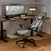 A gaming chair with an extended footrest is shown in a home office setting with a desk and computer monitor. Anteprima dell’immagine prodotto