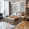 A luxurious bedroom with a large box spring bed as the focal point. Voir les images du produit