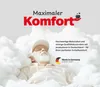 A man is sleeping peacefully surrounded by clouds, with text indicating maximum comfort and quality production in Germany. Produktbild-Vorschau