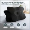 Two black orthopedic neck pillows are displayed on a bed with a bedside table and lamp in the background. Below the pillows are four circular icons with text. Produktbild-Vorschau