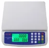 A white and blue digital price computing scale with a green LED display and a numeric keypad. Produktbild-Vorschau
