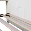 Close-up view of the slatted base of a beige upholstered bed frame. Produktbild-Vorschau