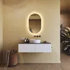 A modern bathroom vanity with a sink, mirror, and accessories. Náhled obrázku produktu