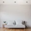 A minimalist living room scene with a white sofa and a small side table with a plant. Produktbild-Vorschau