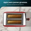 A red toaster with two slices of toast inside, placed on a marble-like surface. Náhľad obrázku produktu