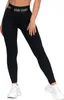 A person wearing black leggings and white sneakers against a white background. Produktbild-Vorschau