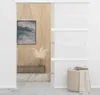 A room with a sliding door, a painting on the wall, and a basket with blankets. Náhľad obrázku produktu