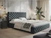 A bedroom scene featuring a tufted upholstered bed.